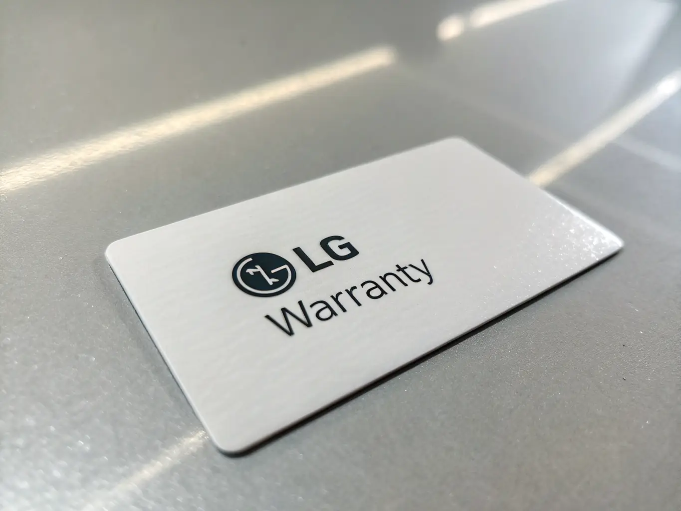 A warranty card with a 2-year guarantee seal, placed on top of a brand new padel racket, illustrating the warranty coverage offered by PadelPrestige.